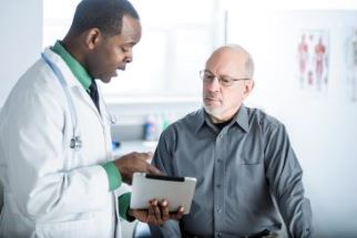Older man talking with his doctor about colonoscopy results