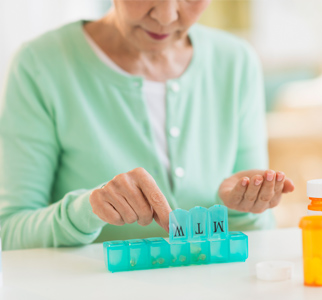 woman holding pill organizer