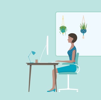 Woman sitting at a desk with good posture