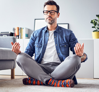 Man sitting on floor meditating