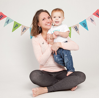 A mother holding a toddler on his first birthday.