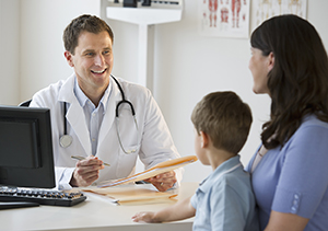 Doctor talking to woman and child.