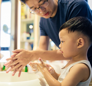 Dad and toddler washing hands
