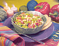 Mediterranean diced salad in a bowl with pita bread.